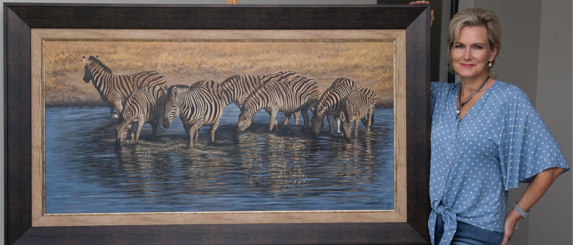 Ilse de Villiers standing next to Zebra painting - Where stripes & reflected sky meet